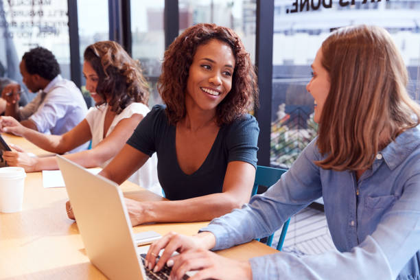 istock Businessmen And Businesswomen Working In Shared Open Plan Office Workspace 1210055649