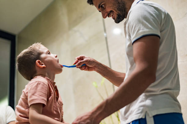 istock Father and son brushing teeth in bathroom 1210055666