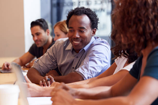 istock Businessmen And Businesswomen Working In Shared Open Plan Office Workspace 1210055729