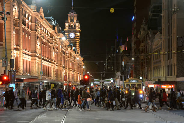 Crowd crossing the street at Flinders Street railway station, Melbourne, Australia Crowd of people crossing the street at Flinders Street railway station in Melbourne, Victoria. 
It is the busiest station on Melbourne's metropolitan network. The main station building, completed in 1909, is a cultural icon of Melbourne. It is listed on the Victorian Heritage Register. melbourne street crowd stock pictures, royalty-free photos & images