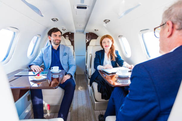 istock Business people sitting in private airplane 1210059245