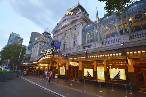 People walking by the Princess Theatre at dusk, a 1488-seat theatre in Melbourne's East End Theatre District, Australia, the oldest continuous entertainment site on mainland Australia. It is listed on the Victorian Heritage Register.