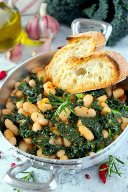 istock Stewed beans with black cabbage served with toasted bread. 1210069827
