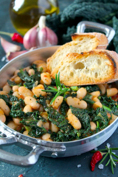 istock Stewed beans with black cabbage served with toasted bread. 1210069892