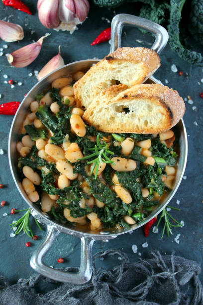 istock Stewed beans with black cabbage served with toasted bread. 1210069901