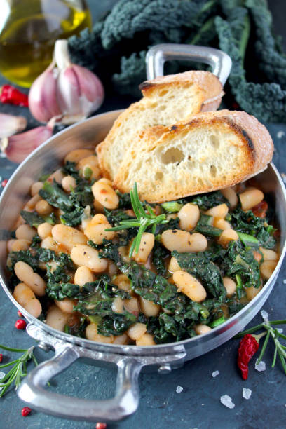 istock Stewed beans with black cabbage served with toasted bread. 1210069910