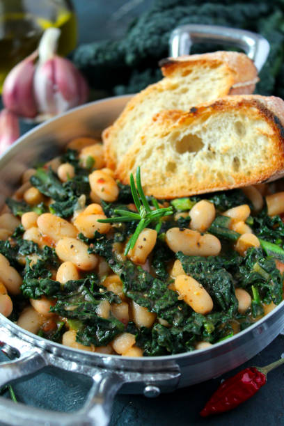istock Stewed beans with black cabbage served with toasted bread. 1210070091