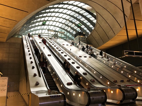 London, United Kingdom - February 2 2020: Canary Wharf station main entrance and exit escalators with people