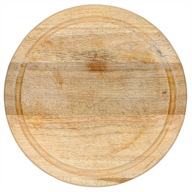 istock Worn, well-used, circular, natural wood, kitchen cutting board. Isolated on white, clipping path included. 1210073440