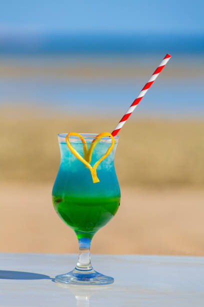 istock Colorful cocktail drink in glass at beach 1210074873