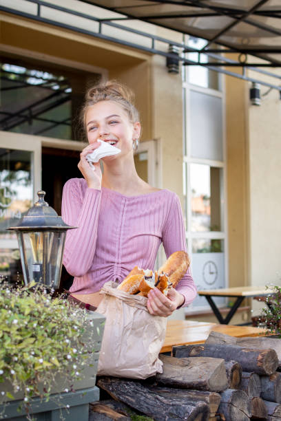 teenager girl eating a fresh croissant