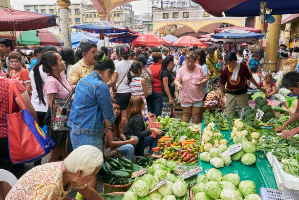 Crowded weekly food market in Quiapo, Manila, Asia Manila, Philippines - February 12, 2017: Crowded weekly market next to the famous landmark Quiapo Church, with vegetables coming mostly from Baguio divisoria market stock pictures, royalty-free photos & images