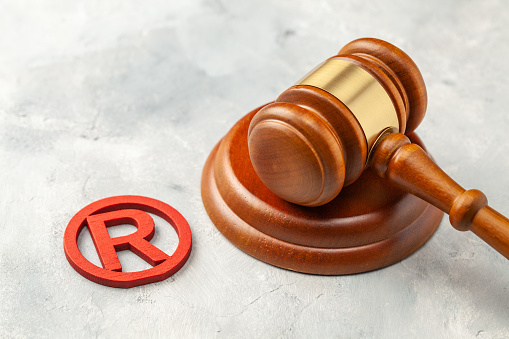 Judge gavel and red trademark sign.
