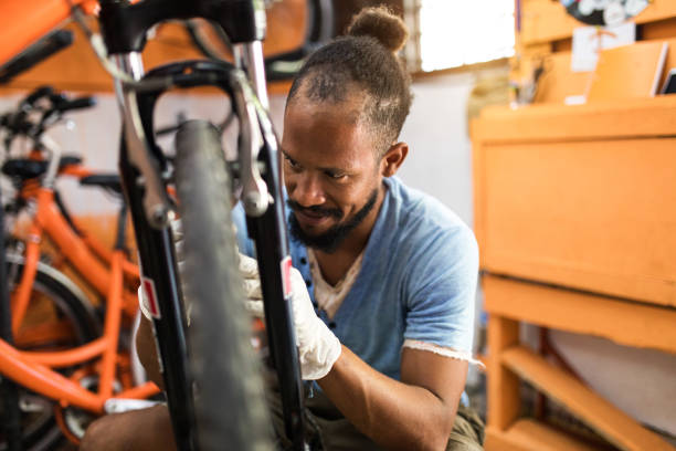 istock Happy owner of bicycle shop working on bicycle 1210081692