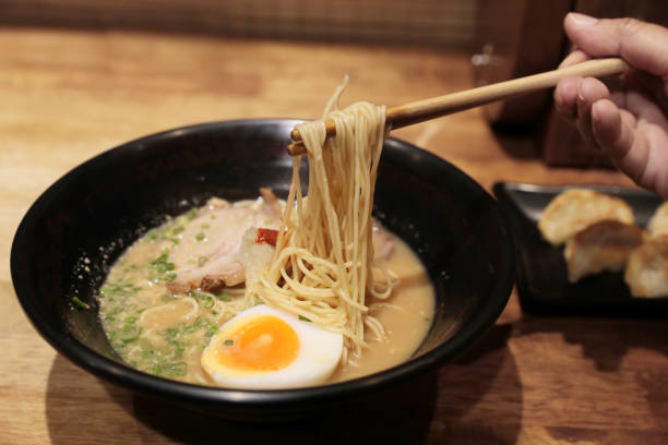 istock Chopsticks on ramen noodles with boiled eggs 1210087582