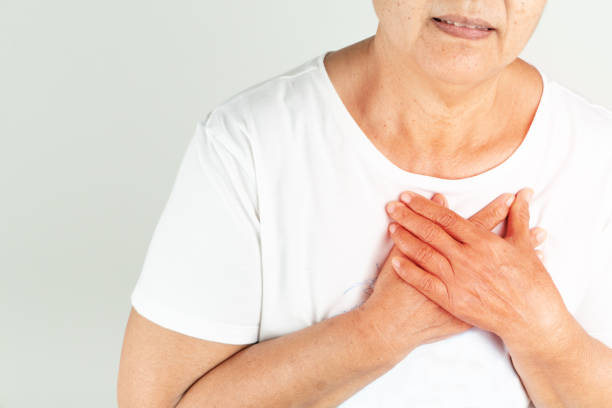 istock Old woman heart attack holding breast on white background 1210087805