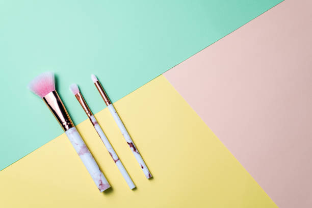 istock Set of makeup brushes on pastel background. Cosmetics accessories for makeup. Minimal composition. Fashion, beauty, makeup concept 1210087840