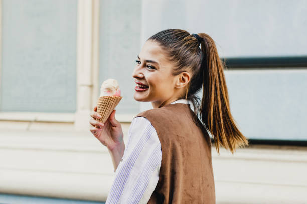 istock Young woman eating ice cream 1210088070