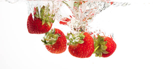 istock Strawberries falling into water causing bubbles all around it. Healthy food concept 1210088226