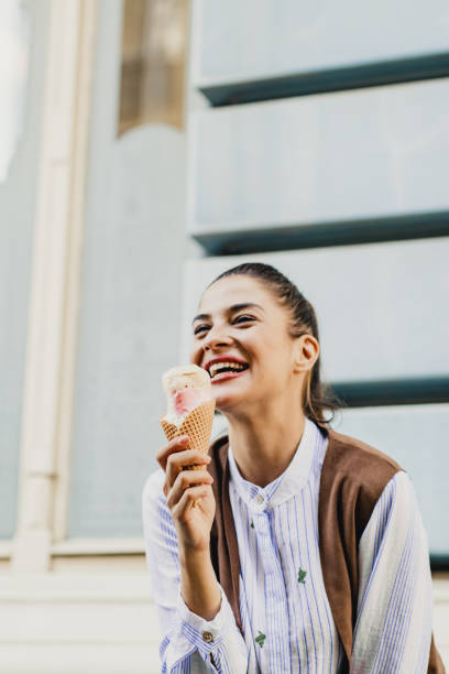 istock Young woman eating ice cream 1210088286