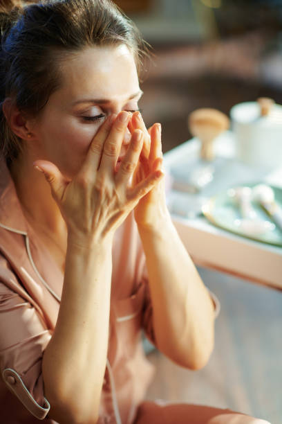 istock elegant woman applying cream and making massage 1210089771