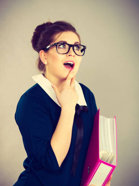 istock Happy positive business woman holding binder with documents 1210090191