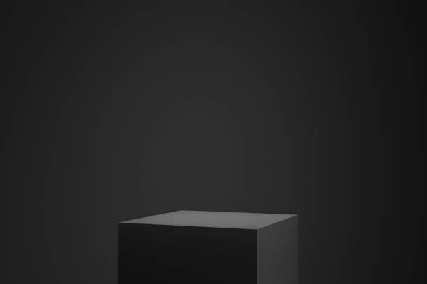 istock Black podium or pedestal display on dark background with cube platform. Blank product shelf standing backdrop. 3D rendering. 1210090910