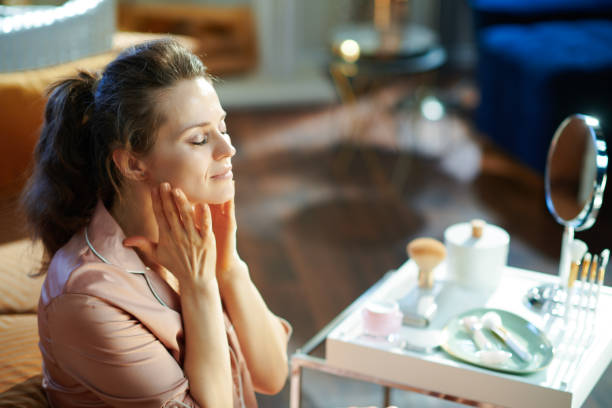 istock relaxed woman applying cream and making massage 1210094444