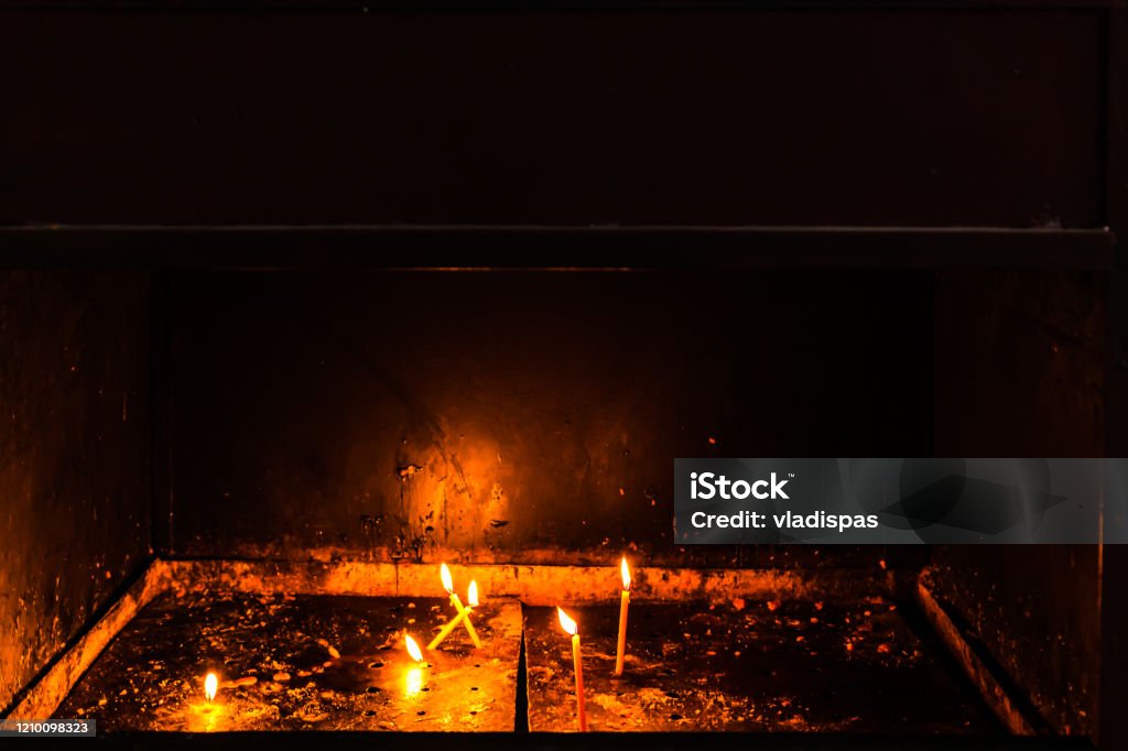 Lighting candles in a orthodox church. Close up. Black Color Stock Photo