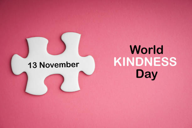 world kindness day  text with white jigsaw puzzle on pink background - november calendar pink event imagens e fotografias de stock