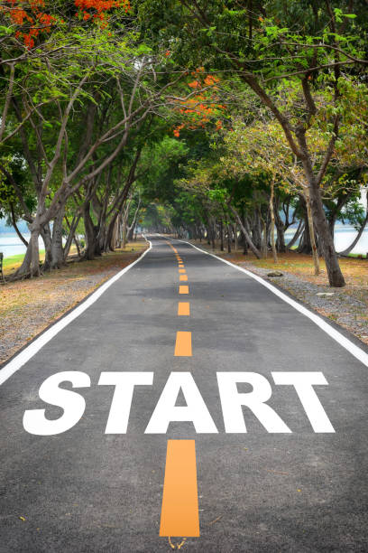 istock Tree tunnel with start word on asphalt road surface 1210102008