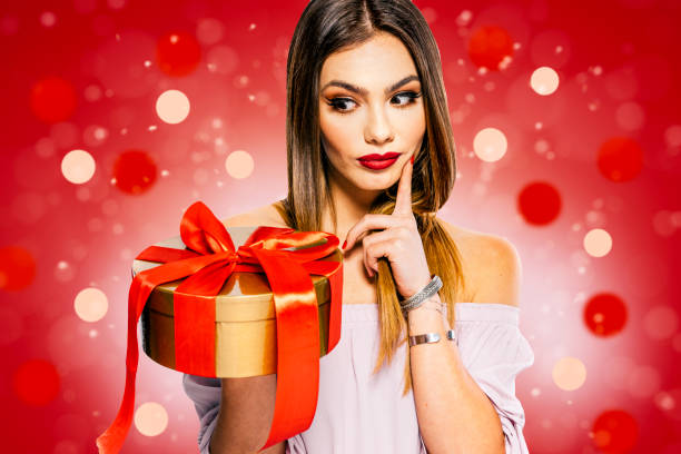 istock Beautiful young woman model with present box 1210104301