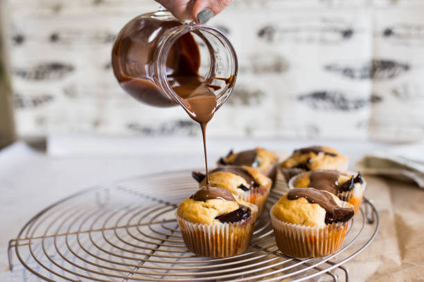 istock Pouring chocolate on homemade muffins 1210107641