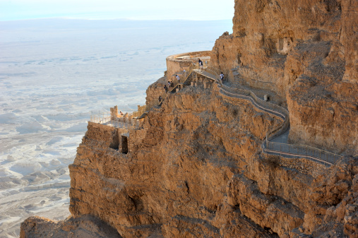 Masada, Israel - February 27, 2024: Israeli soldiers descend Masada on foot. Masada is an ancient fortification near the Dead Sea, situated on top of an isolated rock plateau.