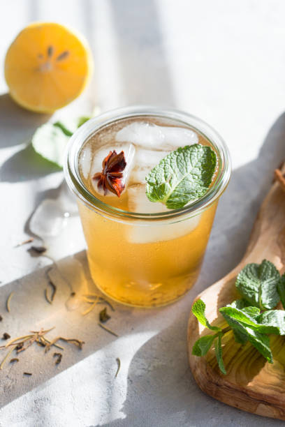 Cold Lemon green tea in glass with anise ice. Heathy summer probiotic drink Cold Lemon green tea in glass with anise ice. Heathy summer probiotic drink heathy stock pictures, royalty-free photos & images