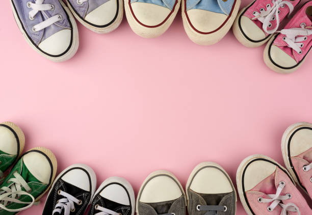 istock many multi-colored well-worn textile sneakers of different sizes on a pink background, top view 1210113747