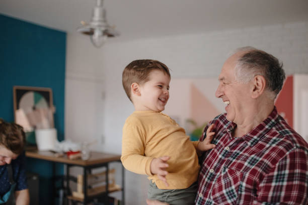 istock Grandfather holding grandson and smiling 1210115831