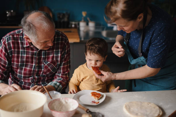 istock Grandmother feeding grandson 1210115954