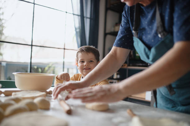 istock Grandmother and grandson having fun preparing dough in the kitchen 1210115983