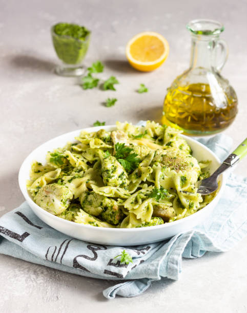istock Pasta with green sauce and roaster cauliflower on a white plate. Copy space. 1210116623