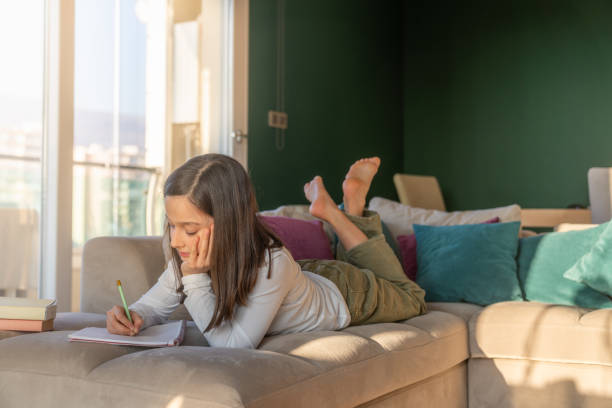 istock little girl doing homework at home 1210119459