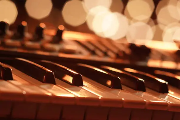 Entertainment piano keyboard with a backdrop of golden bokeh