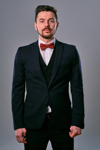 Young Business Man In Classic Black Suit White Shirt And Red Bowtie Posing Against A Gray Studio Background Mock Up Copy Space Closeup Stock Photo - Download Image Now - iStock Young Business Man In Classic Black Suit White Shirt And Red Bowtie Posing Against A Gray Studio Background Mock Up Copy Space Closeup Stock Photo - Download Image Now - Istock