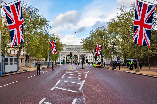 London, UK - April 2019: Mall street with UK flags and Admiralty Arch on Trafalgar square