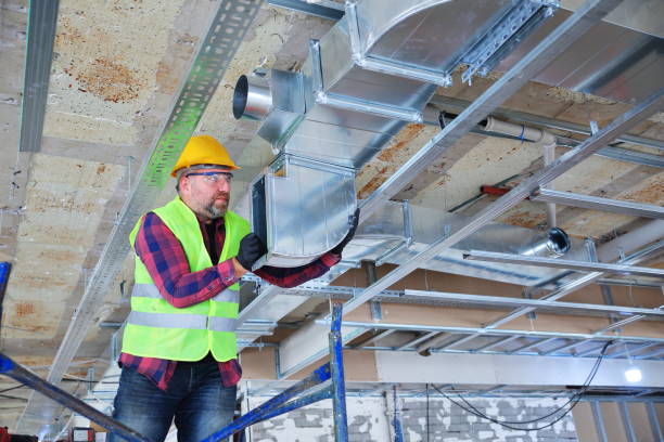 istock Manual Worker  installing air conditioner in building 1210120160