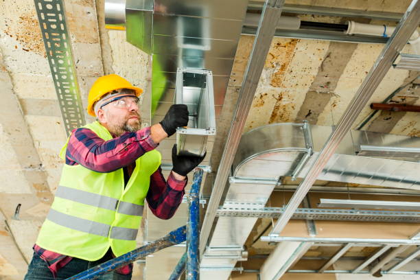 istock Manual Worker  installing air conditioner in building 1210120207