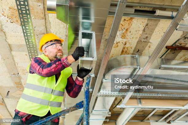 Manual Worker Installing Air Conditioner In Building Stock Photo - Download Image Now