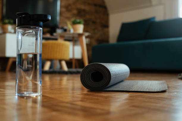 istock Exercise mat and water bottle on the floor. 1210120265