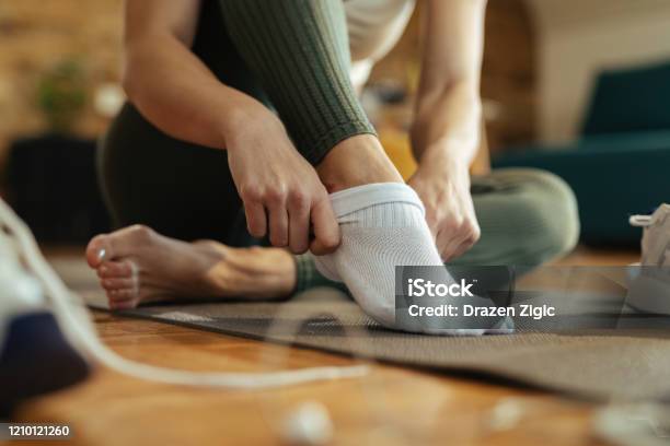 Closeup Of Athletic Woman Putting On Socks Stock Photo - Download Image Now - Sock, Women, Getting Dressed