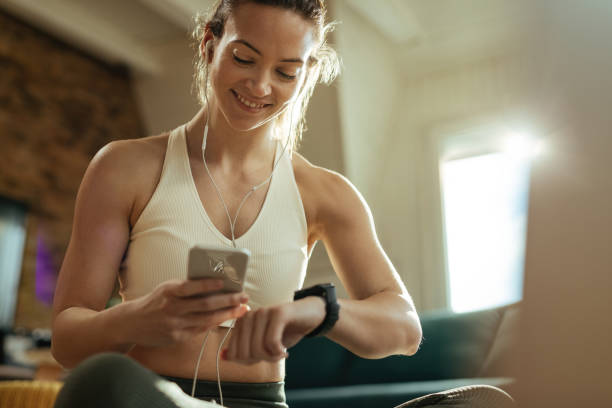 istock Happy athletic woman using smart phone while measuring her heart rate. 1210121565